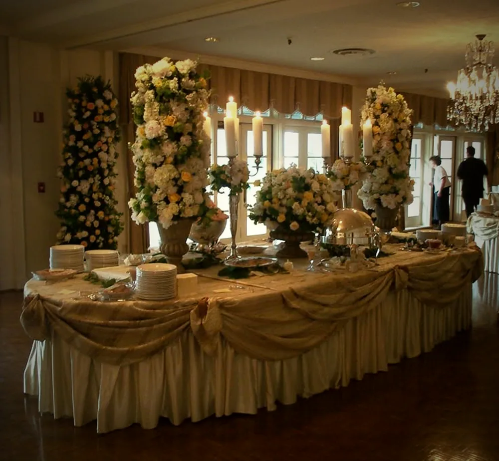 Floral-draped reception buffet at a ballroom wedding