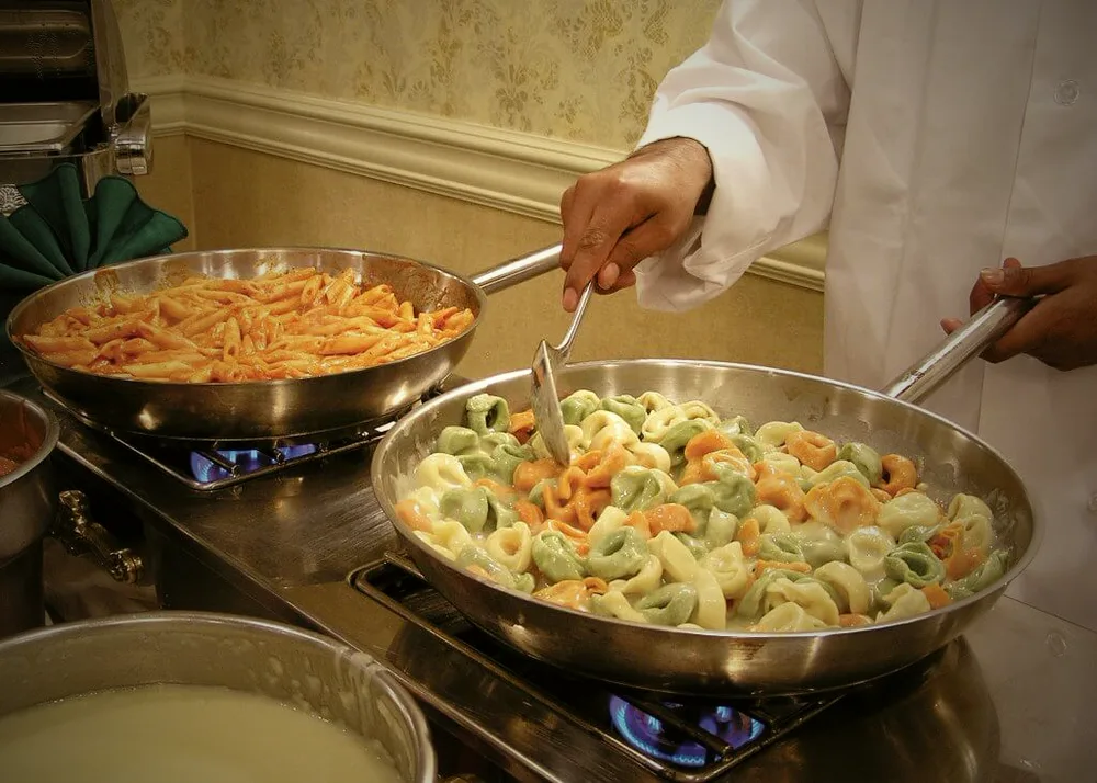 Chef finishing penne and tortellini to order